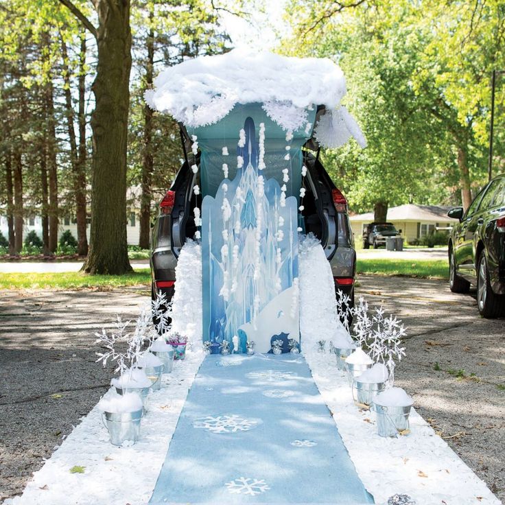 a car is parked in front of an ice - covered walkway with cups on it