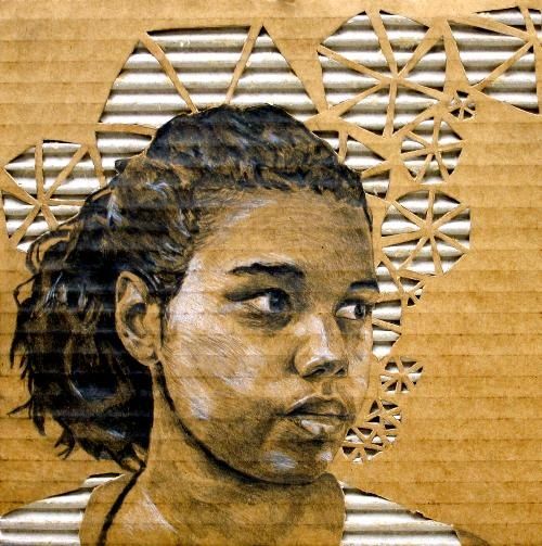 a drawing of a woman's face on a piece of cardboard