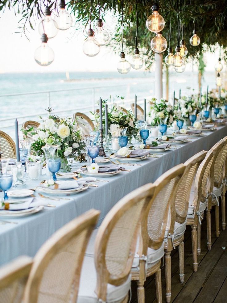 a long table is set with blue and white plates