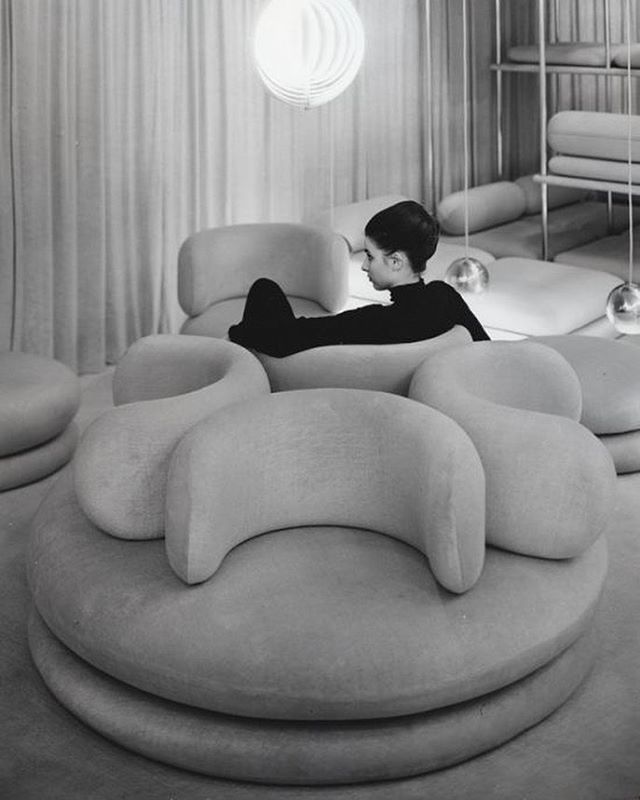 a man laying on top of a couch in a living room