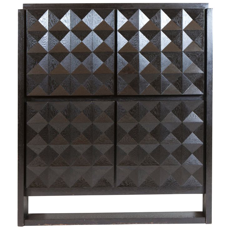 a wooden cabinet with three doors and geometric designs on the front, in dark wood