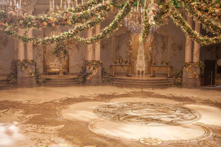 an elaborately decorated room with chandeliers and flowers