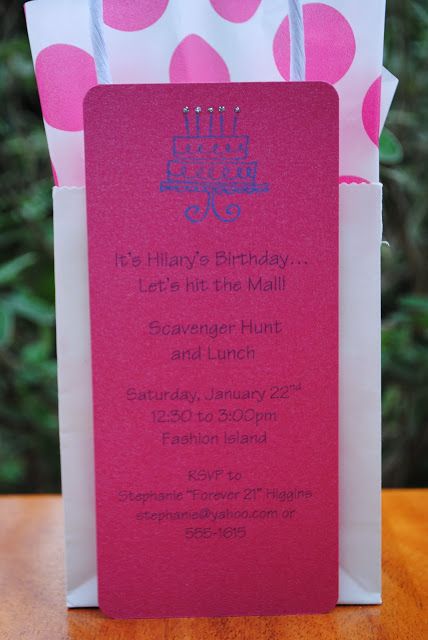 a pink and white birthday bag on top of a wooden table