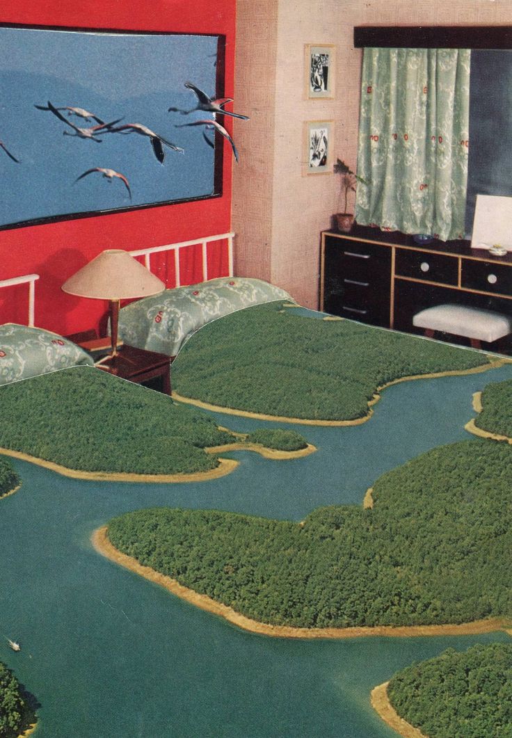 two beds in a room with green grass on the floor and birds flying over them