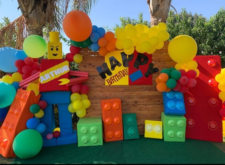 a lego themed birthday party with balloons and decorations