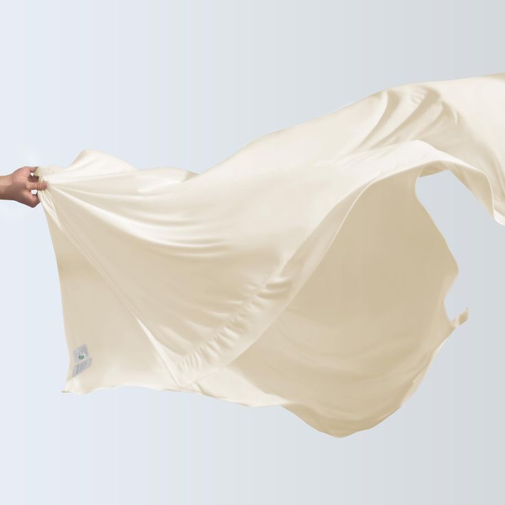 a person holding a white cloth in the air