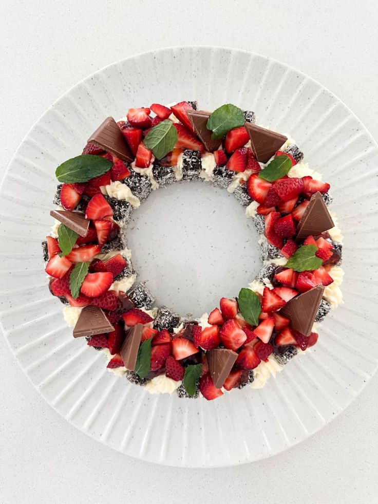 a white plate topped with strawberries and chocolate