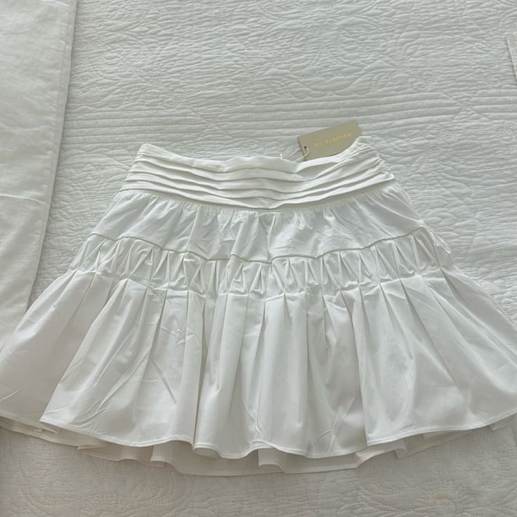 Nwt. Never Worn. Pristine Condition Kimmy Skirt. Color Is Ivory Color In Photo Is Only To Show It Being Worn. Size L. Fits Like 8-10 Beautiful Skirt For Season. Can Dress Up Or Down Elegant Spring Skort With Gathered Skirt, Elegant Cotton Skort With Lined Skirt, Elegant Cotton Tennis Skirt With Lined Skirt, Elegant Cotton Lined Skort, Elegant Cotton Tennis Skirt With Lining, White Relaxed Mini Skirt With Lining, White Full Skort With Lined Skirt, White Full Skirt Lined Skort, White Mini Pleated Skirt For Spring