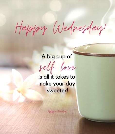 a cup of coffee sitting on top of a wooden table next to a white flower