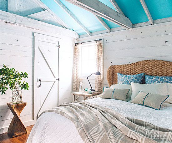 a bed with blue and white sheets in a room