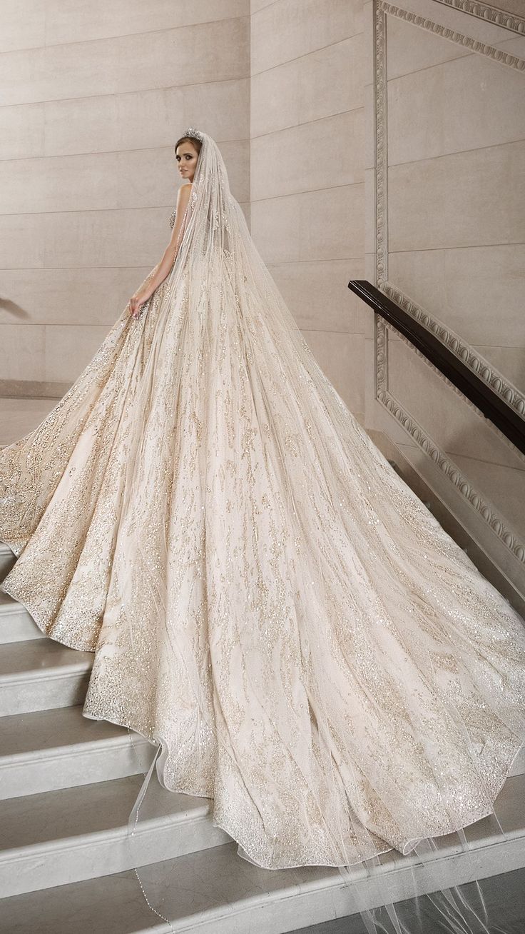 a woman in a wedding dress standing on some stairs