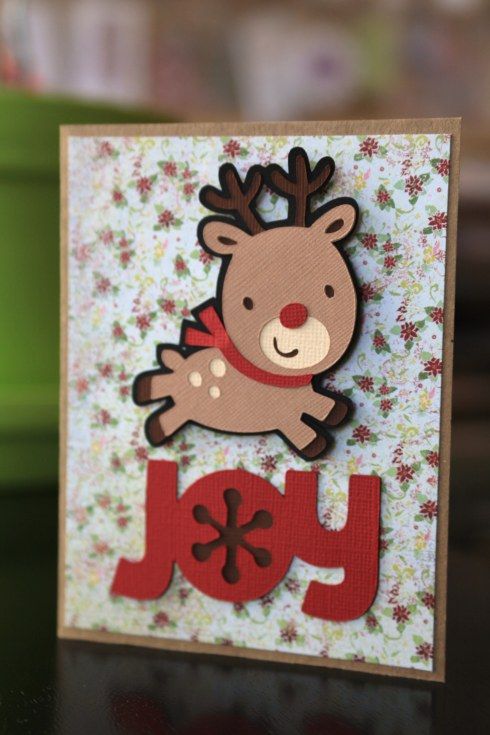 a close up of a christmas card with a reindeer on it's head and the word joy written in red