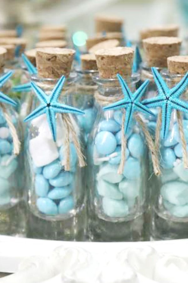 small glass bottles filled with blue and white candies