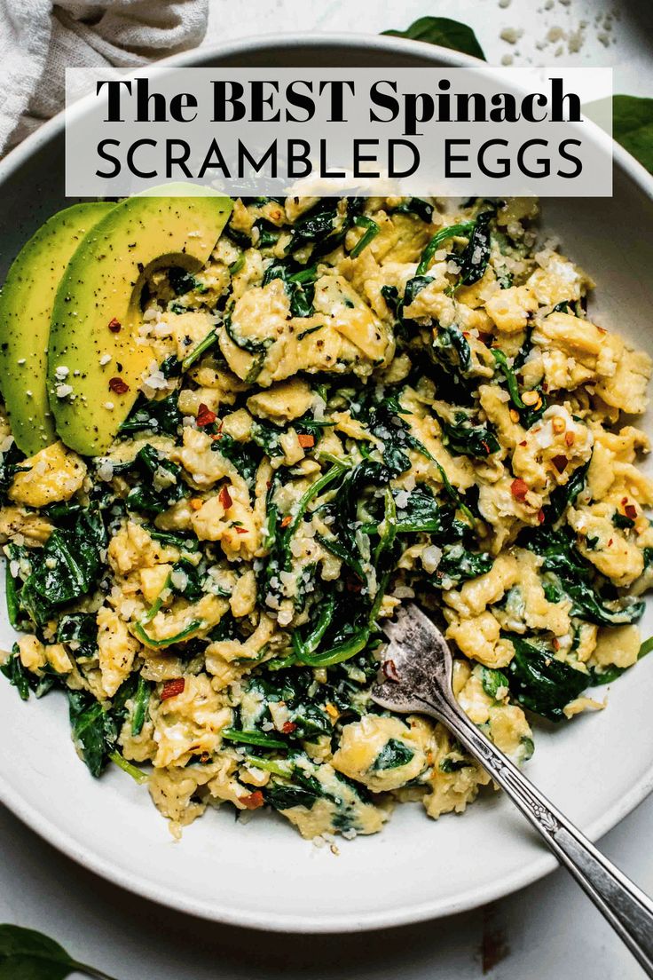 the best spinach scrambled eggs in a bowl with avocado on the side