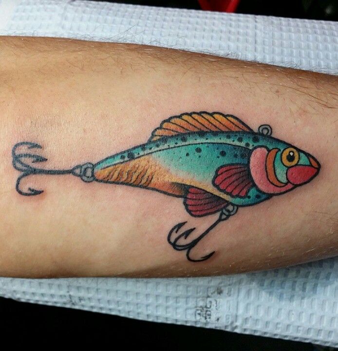 a colorful fish tattoo on the left arm and leg, with a fishing hook attached to it