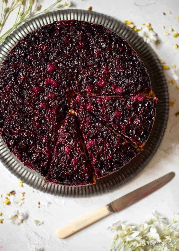 a pie sitting on top of a metal pan covered in cranberry toppings