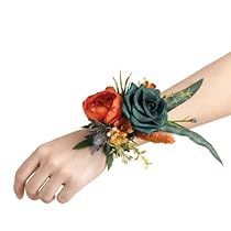 a woman's arm with flowers and leaves on it, including an orange rose