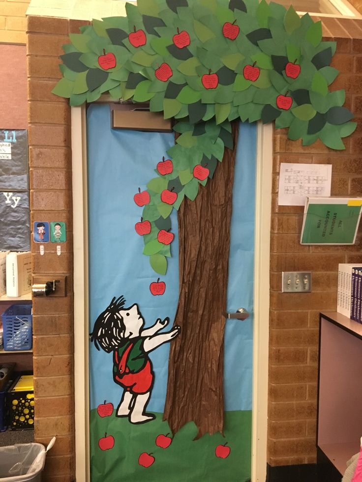 a classroom door decorated with an apple tree