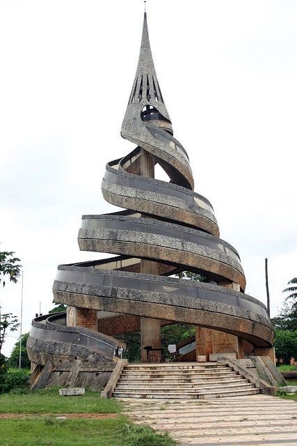 a large wooden structure with steps leading up to it and a steeple in the background