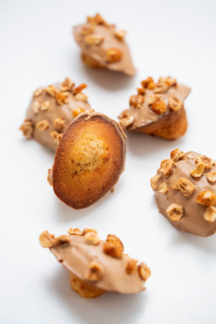 some donuts with chocolate frosting and nuts on top