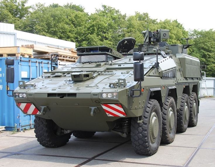 an army vehicle is parked on the street