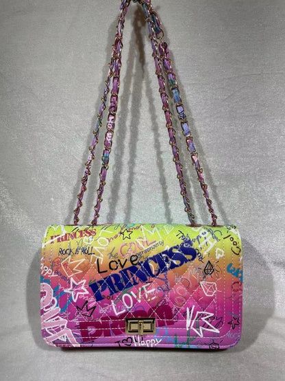 Make your street style look POP with this on-trend Graffiti Bag! Featuring a graffiti print, quilted design and eye-catching rainbow chain, this unique piece adds a touch of rebellious fun to every outfit. Go out with a bang! Graffiti Bag, Spring Vacation, Graffiti Prints, Purple Bags, Accessories Bags Purses, Street Style Looks, Style Gift, Smooth Texture, Shopping Trip