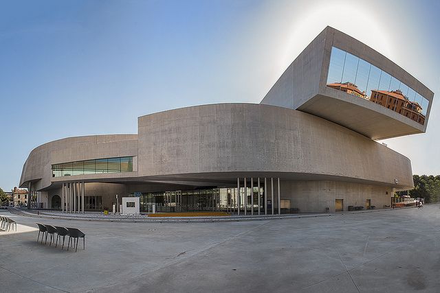 the building is made out of concrete and has an unusual design on it's side