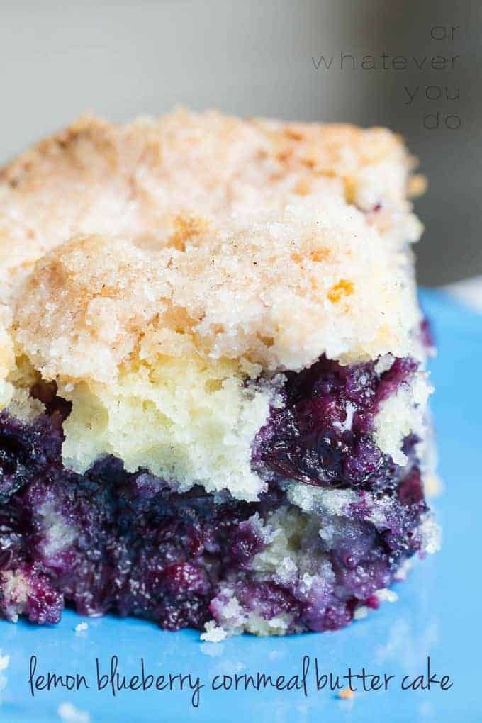 a piece of blueberry crumb cake on a plate with a bite taken out of it