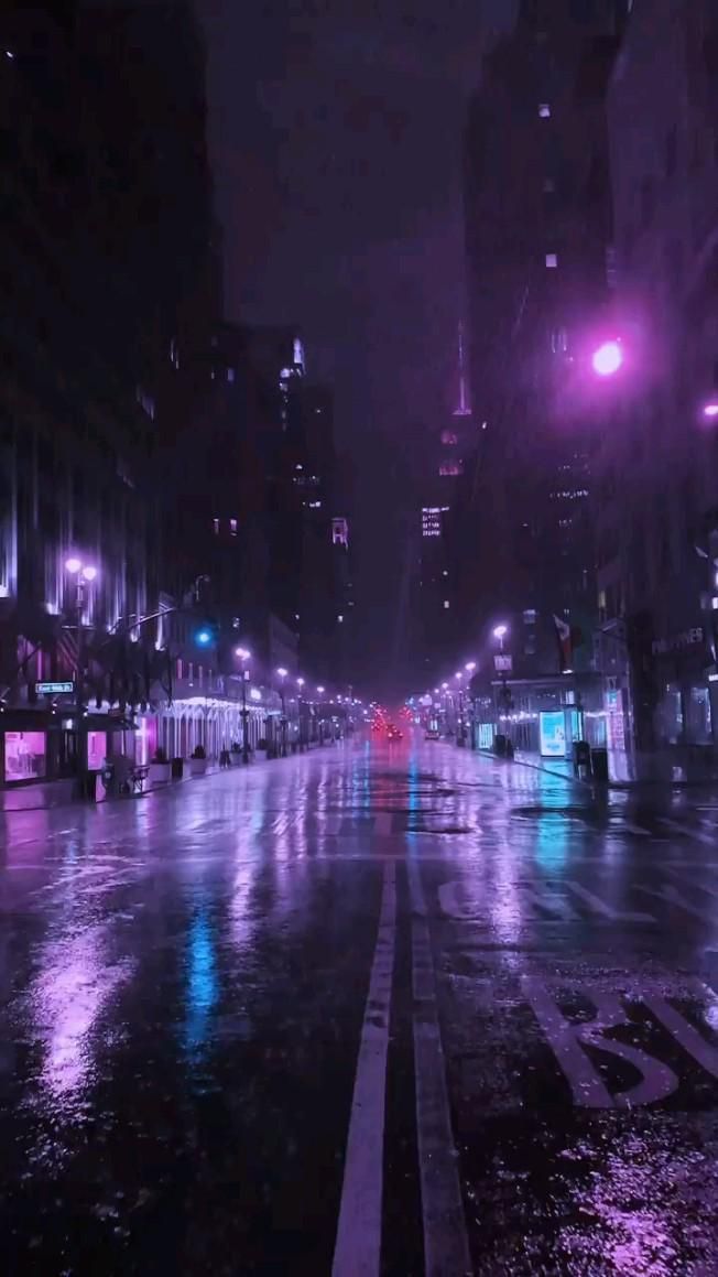 an empty city street at night in the rain with purple lights shining down on it