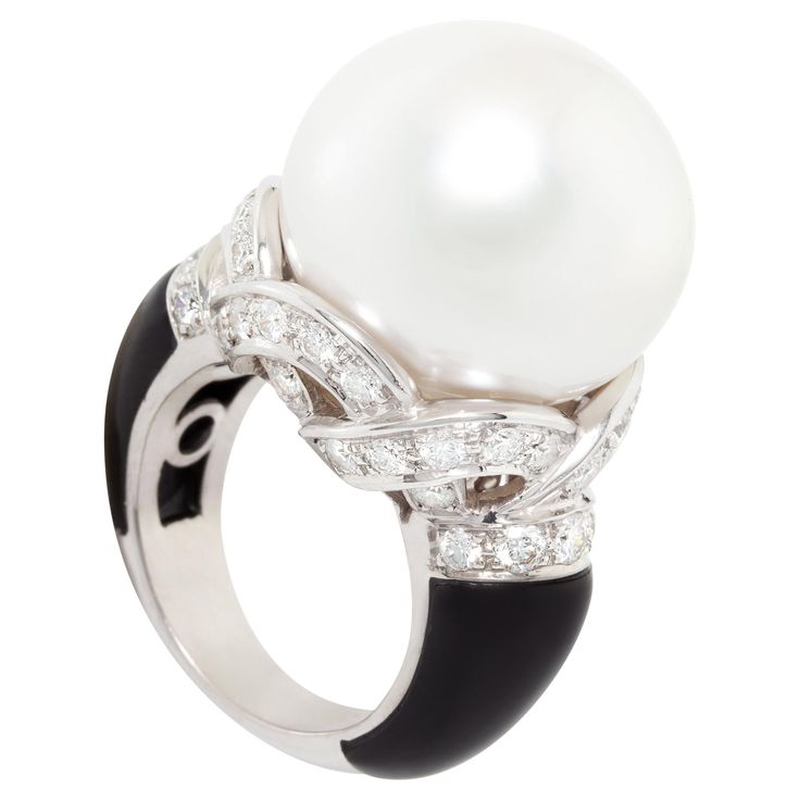 The South Sea pearl and diamond cocktail ring features an exceptionally large and beautiful Australian pearl of the rare dimension of 19.5mm diameter. The pearl is untreated. It displays a fine quality nacre and its natural color and luster have not been enhanced in any way. The pearl is perched on a crown-like design set with top quality round diamonds (F/G-VVS) for a total weight of 2.05 carats. The flanks of the shank are set with custom-cut black onyx, lending the jewel a distinctive art déc Cocktail Ring Designs, Pearl Diamond Ring, Pearl Cocktail Ring, Pearl Jewelry Design, Diamond Rings Design, Diamond Cocktail Ring, Colored Engagement Rings, Pearl And Diamond Ring, Gold Cocktail Ring