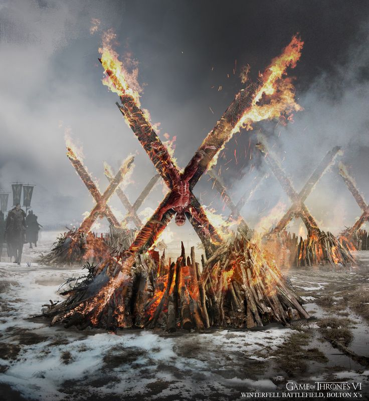 a group of people standing in front of a fire with the letter x on it