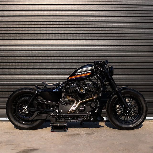 a black motorcycle parked in front of a garage door