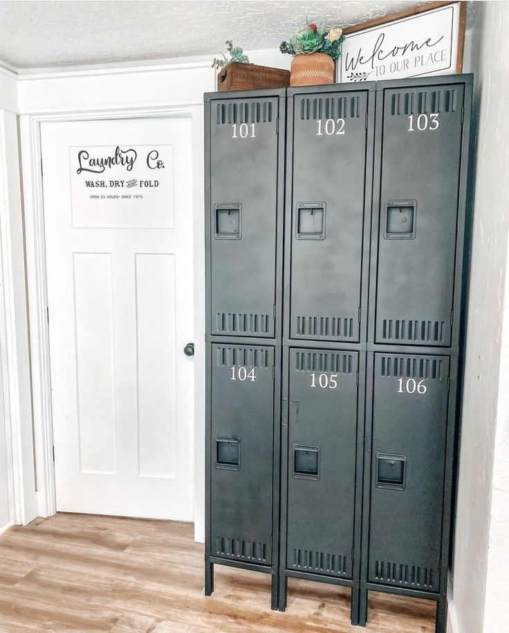 two metal lockers sitting next to each other on a hard wood floor in front of a white door