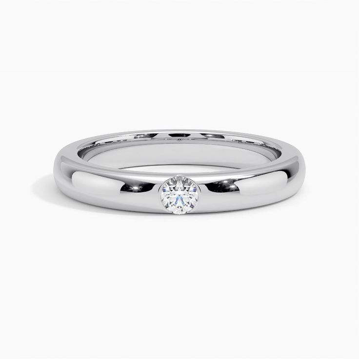 a white gold ring with a single diamond