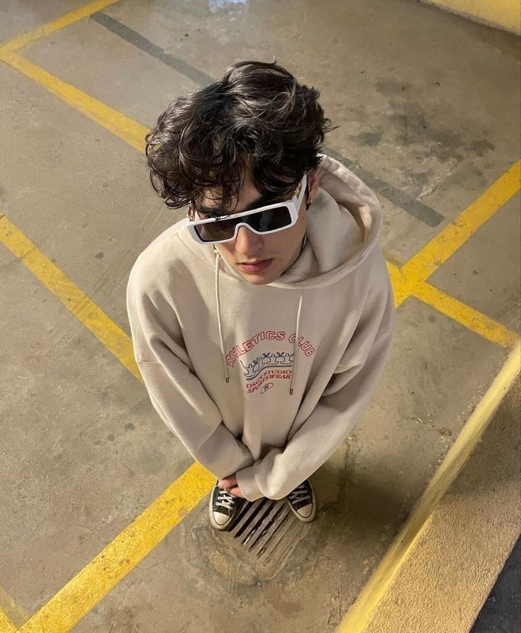 a young boy wearing sunglasses and a hoodie