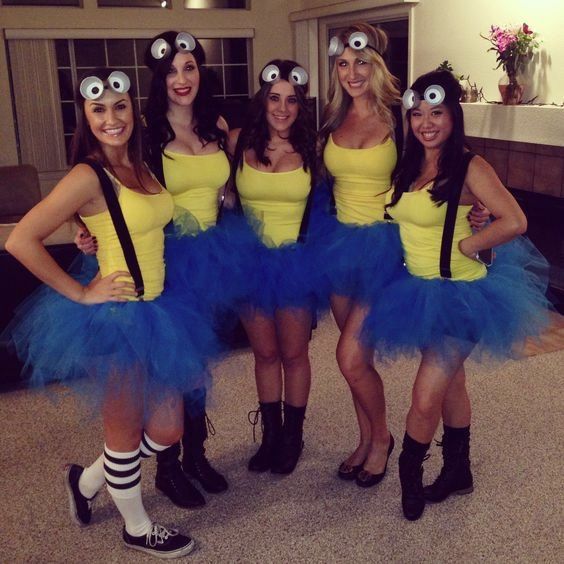 four women dressed up in costumes posing for a photo with their eyes on each side