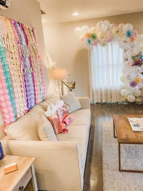 a living room filled with furniture and balloons