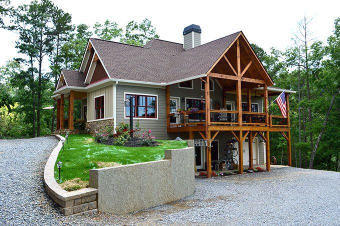 a house in the middle of a gravel driveway