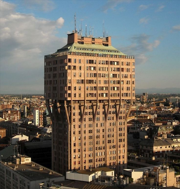 an aerial view of a tall building in the city