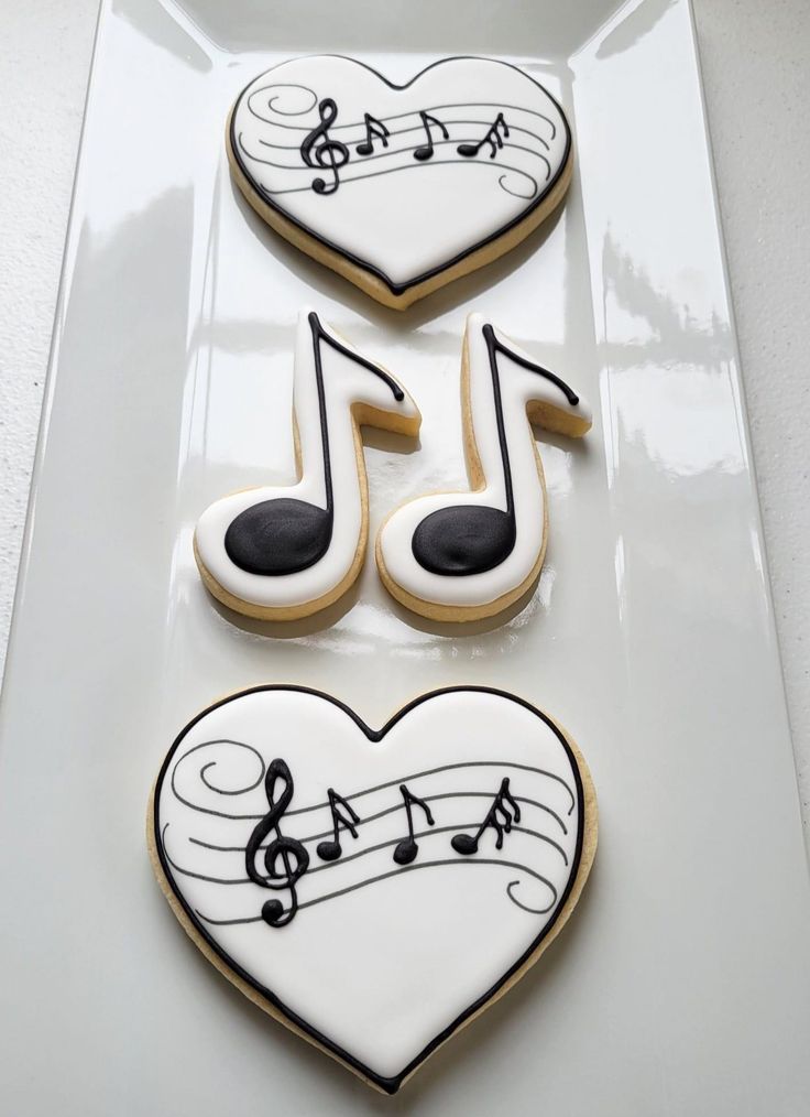 three decorated cookies in the shape of musical notes