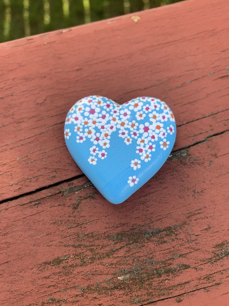 a blue heart shaped object sitting on top of a wooden table