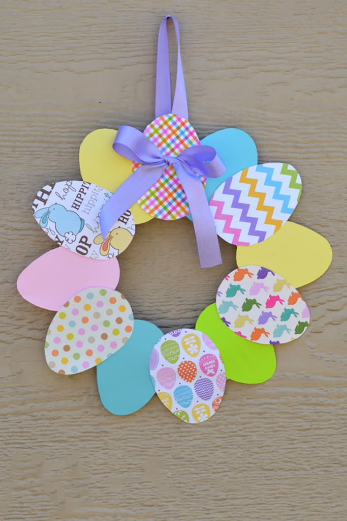 an easter wreath made out of paper and colored eggs