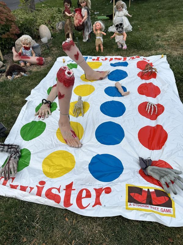 a big blanket that is on the ground in the grass with some toys around it