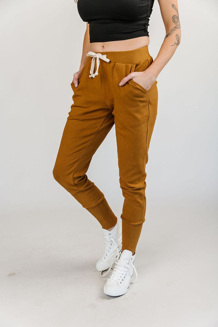 The Ginger Snap Mustard Joggers infuse a pop of color into your outfit, creating a vibrant and eye-catching ensemble. The versatile mustard yellow hue adds a touch of playfulness to your look, while the streamlined design ensures these joggers seamlessly transition from loungewear to streetwear.Ginger Snap: Triple Stretch - New & Improved in Mustard Features: Low profile pockets Elastic waistband Cotton draw string Mustard Relaxed Fit Bottoms For Spring, Trendy Yellow Bottoms With Elastic Waistband, Casual Yellow Cotton Pants, Yellow Sweatpants For Loungewear In Spring, Fitted Cotton Joggers For Fall, Yellow Cotton Sweatpants For Spring, Casual Yellow Sweatpants For Spring, Casual Yellow Bottoms For Loungewear, Fitted Solid Joggers For Fall