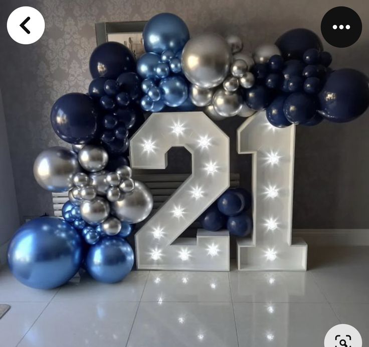 the number twenty two is surrounded by balloons and streamers in blue and silver colors