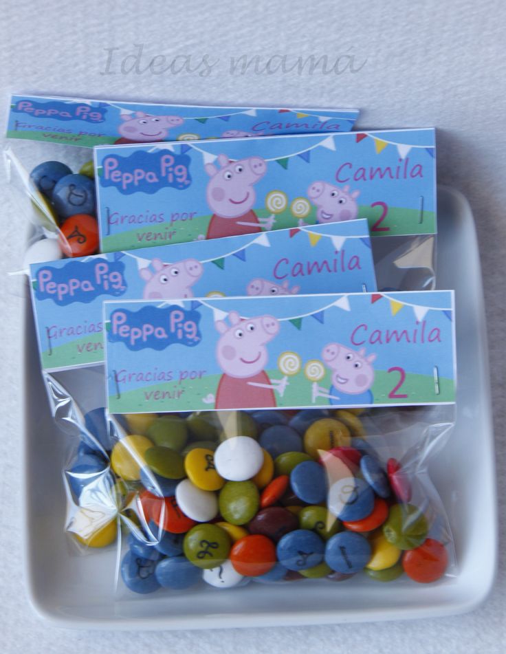 peppa pig candy bar wrappers on a white plate with candies in them