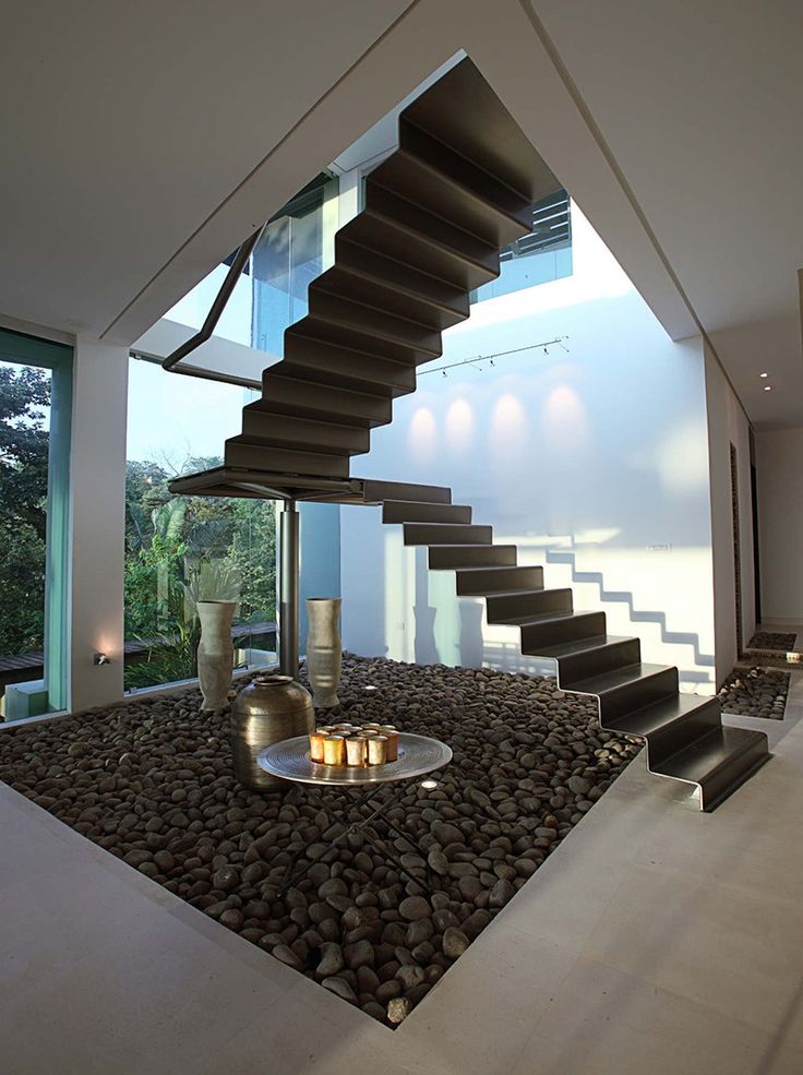 a room with some stairs and rocks on the floor