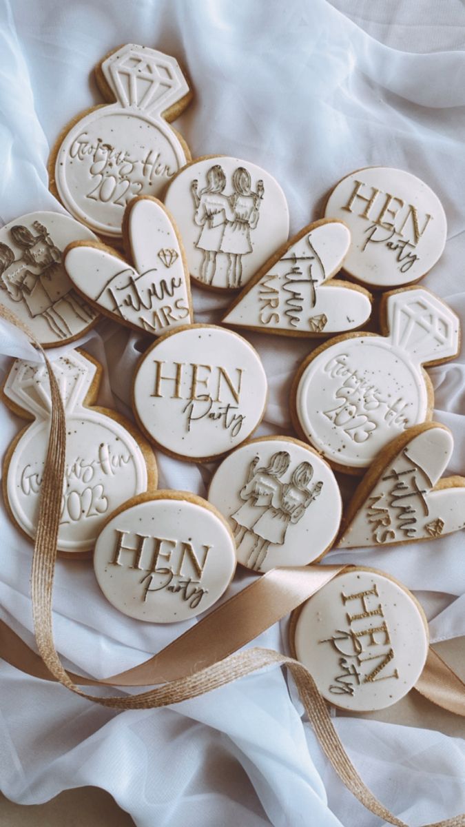 some cookies with writing on them and ribbons