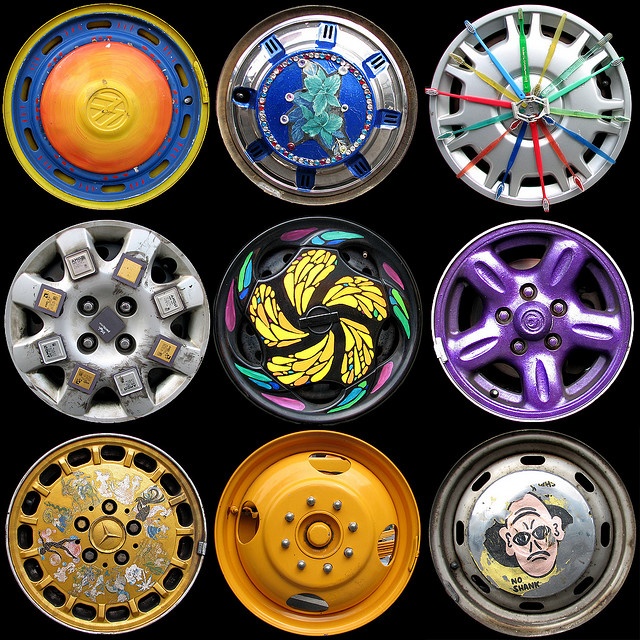 there are many different colored wheels on this black background