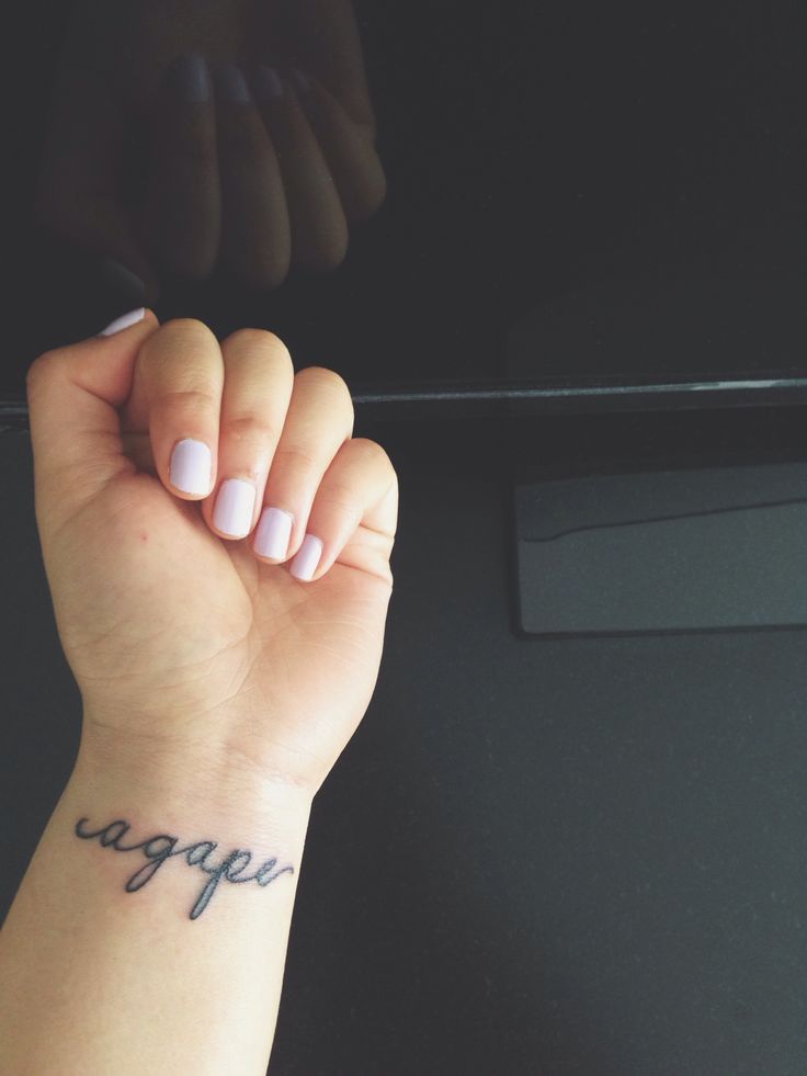 a woman's arm with a tattoo on it and the word agger written in cursive font